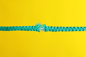 Rupture of blue rope on color background