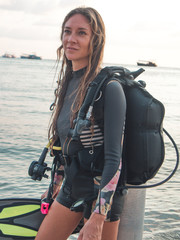 Working mum, super mum. PADI Scuba  Diving Woman with equipment  in the poolside