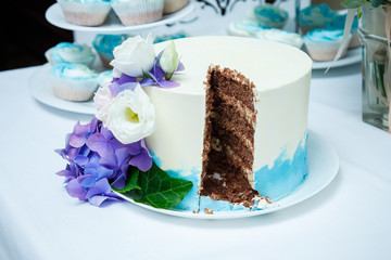 Sweet wedding cake decorated with fresh flowers