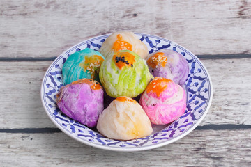  Colorful Chinese pastry moon cake on Thai style plate .