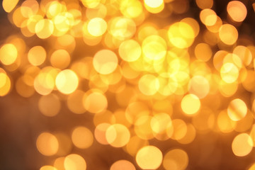 Gold glitter with bokeh effect on dark background