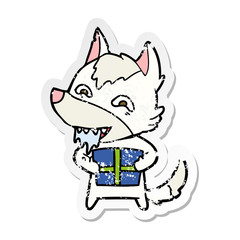 distressed sticker of a cartoon hungry wolf holding christmas present