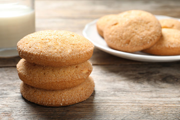 Tasty Danish butter cookies and milk on wooden table. Space for text