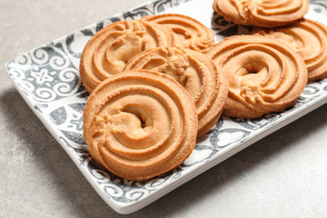 Plate with Danish butter cookies on table, closeup