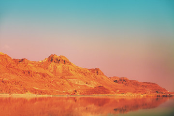 Fototapeta na wymiar Mountainous coast of the Dead Sea in the evening at sunset