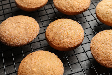 Baking grid with Danish butter cookies on table, closeup