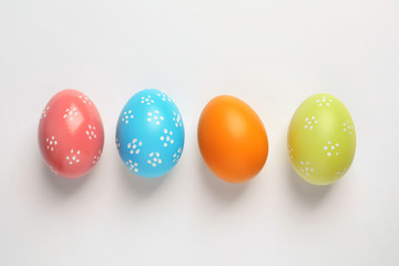 Beautiful painted Easter eggs on white background, top view