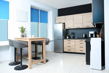 Cozy modern kitchen interior with new furniture and appliances