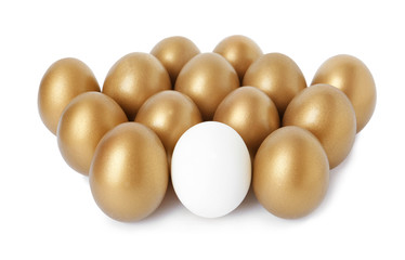 Golden eggs with different one on white background