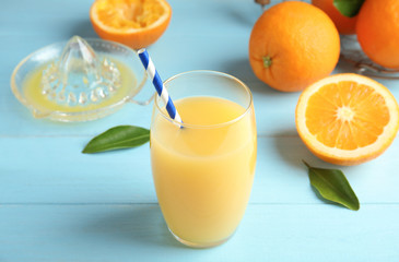 Composition with orange juice and fresh fruit on wooden background
