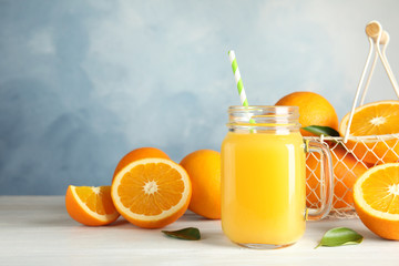 Plakat Composition with orange juice and fresh fruit on table. Space for text