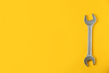 New wrench on color background, top view with space for text. Plumber tools