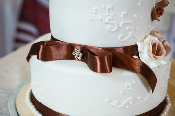 Sweet wedding cake decorated with fresh flowers