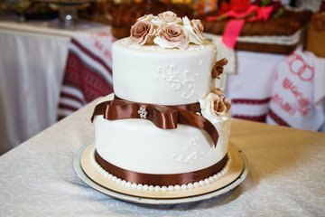 Sweet wedding cake decorated with fresh flowers