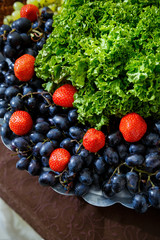 sliced fruits are beautifully arranged on a plate