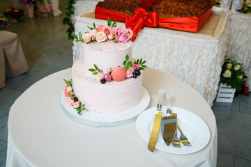 Sweet wedding cake decorated with fresh flowers