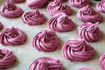 Purple blackcurrant marshmallow on a parchment. Homemade sweets.