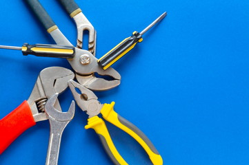 A set of tools for plumbing, isolated on a blue background.