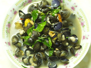 Shell Soup with Garlic, Chilli , Mint and Basil. Traditional Northeast of Thailand food -  Esan Food  name Pad Hoy with Horapa.