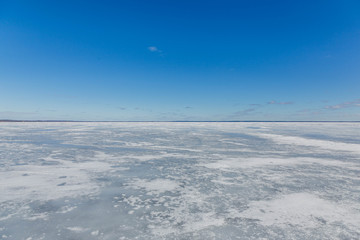 Fototapeta na wymiar Winter landscape with frozen lake in clear weather