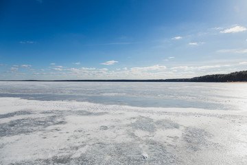 Fototapeta na wymiar Winter landscape with frozen lake in clear weather