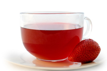 Glass cup of hot aromatic red tea with strawberry