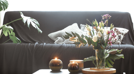 Cozy home interior living room with a vase of flowers and candles