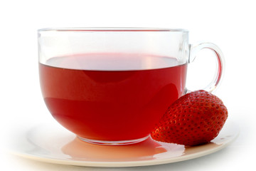 Glass cup of hot aromatic red tea with strawberry