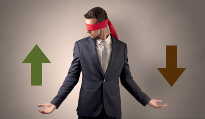 Covered eye businessman choosing between two directions 
