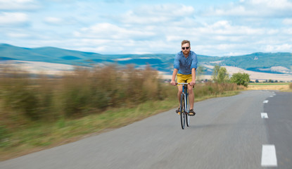 Fototapeta na wymiar Natural view with cyclist going somewhere with stylish bike