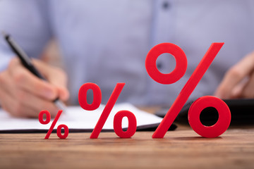 Percentage Sign Near Businessperson Using Calculator