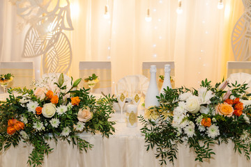 Wedding decor. Table for the newlyweds outdoor. Wedding reception. Elegant wedding table arrangement, floral decoration, restaurant. Wedding in the forest.