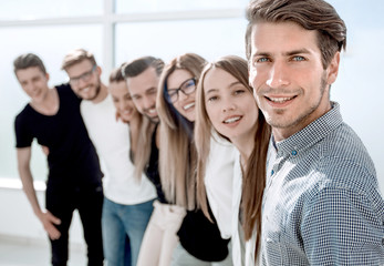 group of successful young people standing in the office