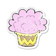 retro distressed sticker of a cartoon cupcake