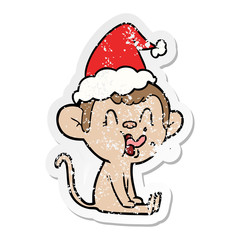 crazy distressed sticker cartoon of a monkey sitting wearing santa hat