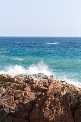 Fototapeta na wymiar Mediterranean Sea water waves crashing on the shore rocks