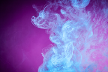 Fog colored with bright blue gel on dark  pink background..