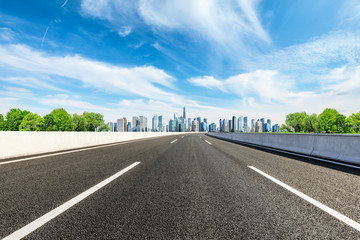 Fototapeta premium Empty asphalt road and panoramic city skyline with buildings in Shanghai