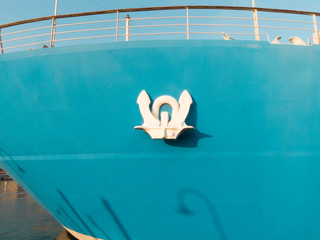 anker white, of a blue ship moored at the port of Genoa