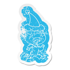 cartoon distressed sticker of a happy boy laughing and running away wearing santa hat