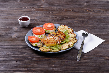 fried and fresh vegetables on a plate with cranberry sauce