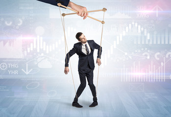Puppet businessman controlled by another hand with financial concept
