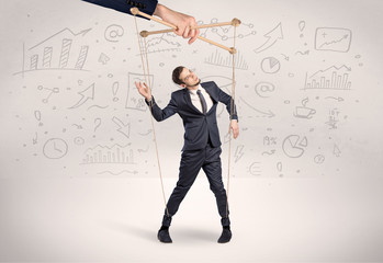 Puppet employee controlled by a big hand with documents and staffs around
