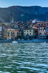 Italy, Bellagio, Lake Como, a small boat in a body of water with buildings in the background