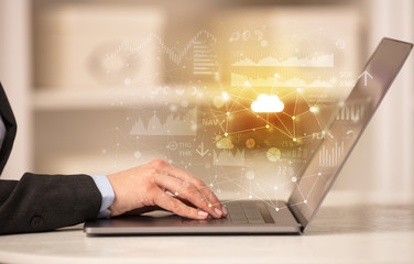 Business woman in homey environment using laptop with cloud technology concept
