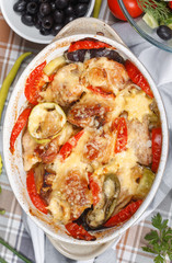 Traditional tasty rustic stew of chicken and vegetables  with Greek salad and black olives