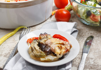 Traditional rustic stew of chicken and vegetables on plate with tomatoes, peppers