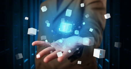 Person holding hologram projection displaying white cubes in server room

