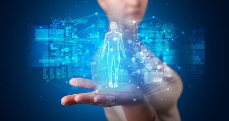 Young person holding hologram projection displaying health related graphs and symbols
