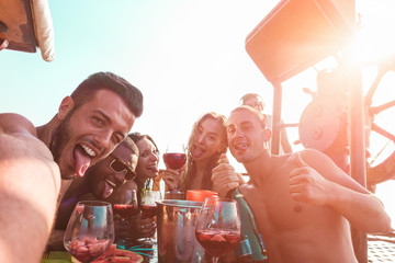 Influencer taking selfie photo with friends for making social network story during boat party -...
